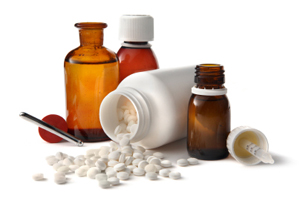 medication bottles with pills spilling out from one of the bottle